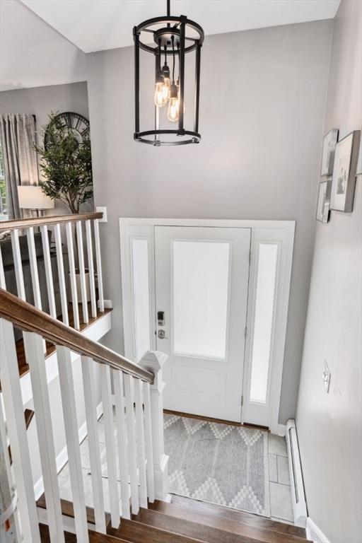 48 W Park Dr, Wakefield, MA 01880 - foyer with a baseboard radiator, stairway, and wood finished floors