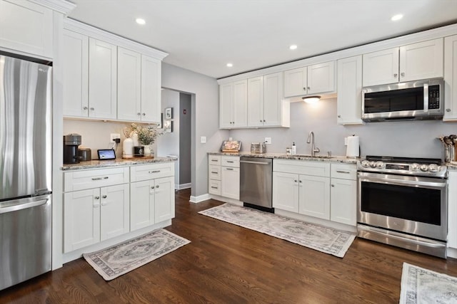 48 W Park Dr, Wakefield, MA 01880 - kitchen with stainless steel appliances, a sink, white cabinetry, dark wood finished floors, and light stone counters