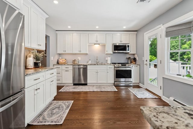 48 W Park Dr, Wakefield, MA 01880 - kitchen featuring appliances with stainless steel finishes, recessed lighting, baseboard heating, white cabinetry, and a sink