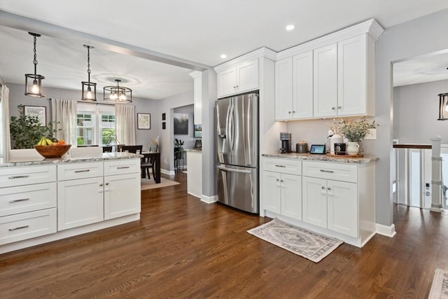 48 W Park Dr, Wakefield, MA 01880 - kitchen featuring stainless steel fridge, white cabinets, dark wood-type flooring, light stone counters, and recessed lighting