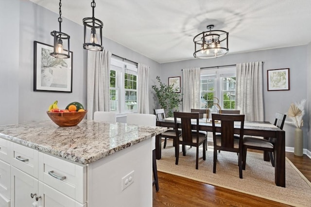 48 W Park Dr, Wakefield, MA 01880 - kitchen featuring a chandelier, white cabinetry, dark wood-style flooring, light stone countertops, and hanging light fixtures