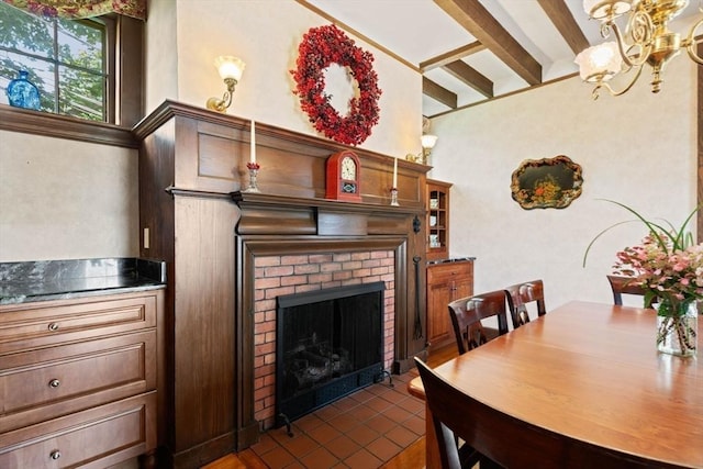 dining area featuring beamed ceiling, a fireplace, and an inviting chandelier