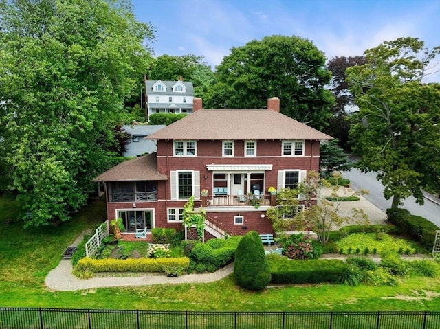 view of front of property featuring stairs, a front yard, a fenced backyard, and a chimney