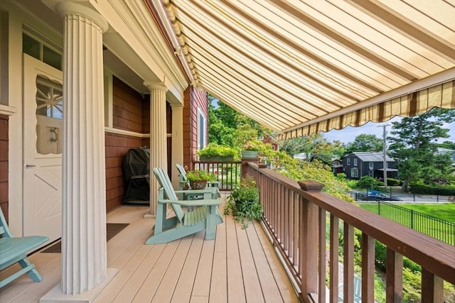 wooden terrace featuring fence