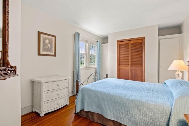 bedroom featuring a closet and dark wood-type flooring