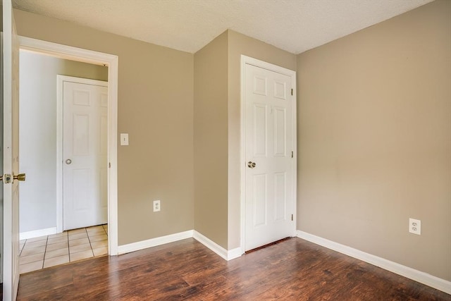39 Lantern Ln Unit 7, Dracut, MA 01826 - unfurnished room with dark wood-style floors and baseboards