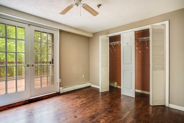 39 Lantern Ln Unit 7, Dracut, MA 01826 - unfurnished bedroom featuring a baseboard heating unit, french doors, a textured ceiling, and hardwood / wood-style floors