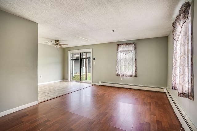 39 Lantern Ln Unit 7, Dracut, MA 01826 - unfurnished room featuring baseboard heating, a textured ceiling, wood finished floors, a ceiling fan, and baseboards
