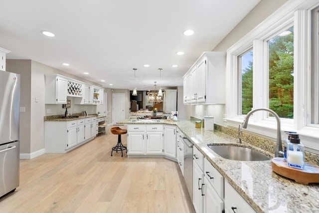 1 Preston Cir, Andover, MA 01810 - kitchen featuring stainless steel appliances, a peninsula, white cabinets, recessed lighting, and light wood finished floors