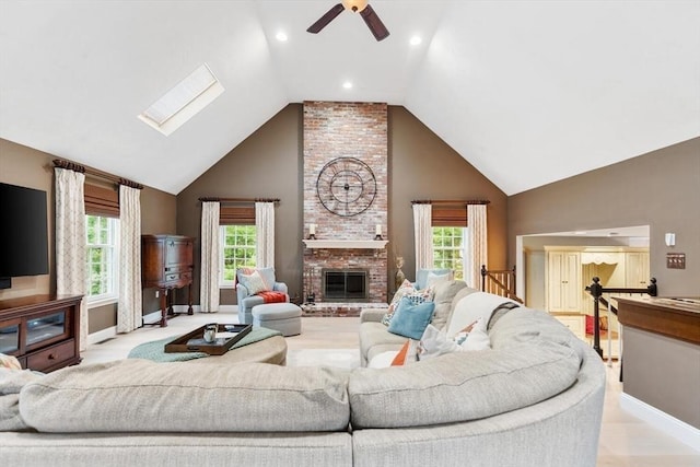 1 Preston Cir, Andover, MA 01810 - living room featuring a ceiling fan, high vaulted ceiling, a skylight, and a brick fireplace