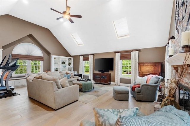 1 Preston Cir, Andover, MA 01810 - living area with a skylight, light wood finished floors, ceiling fan, a fireplace, and high vaulted ceiling