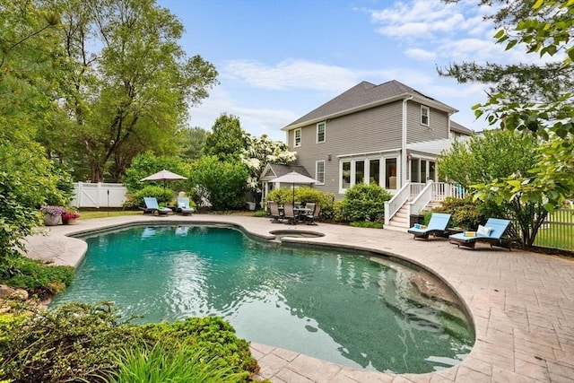 1 Preston Cir, Andover, MA 01810 - view of swimming pool with a patio, a fenced backyard, outdoor dining space, a gate, and a pool with connected hot tub