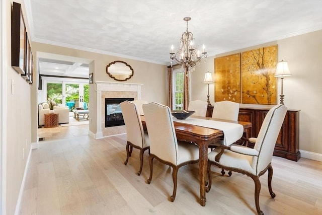 1 Preston Cir, Andover, MA 01810 - dining space featuring light wood-style floors, a chandelier, a fireplace, and ornamental molding
