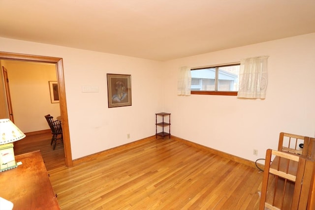 empty room featuring light wood-style floors and baseboards