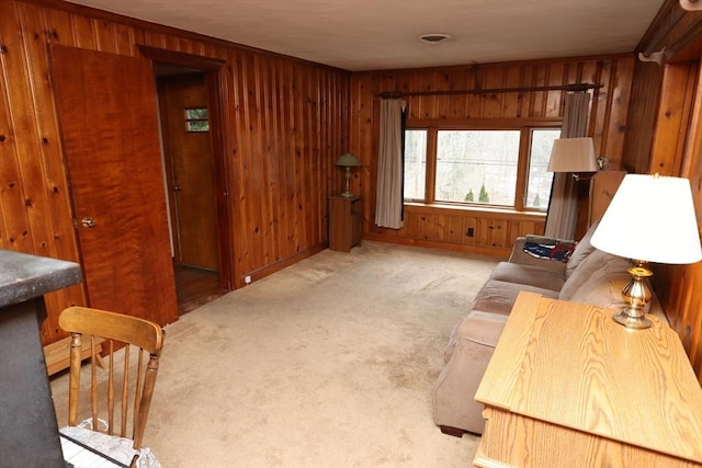 carpeted living area with visible vents and wooden walls