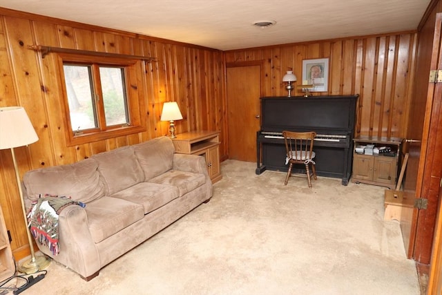 living area featuring light carpet, wood walls, and visible vents