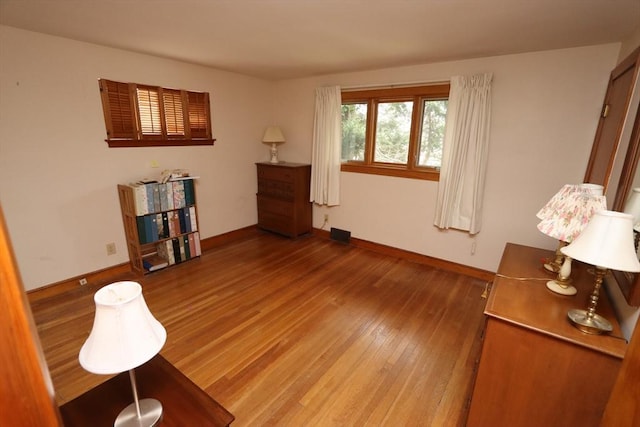 sitting room featuring baseboards and wood finished floors