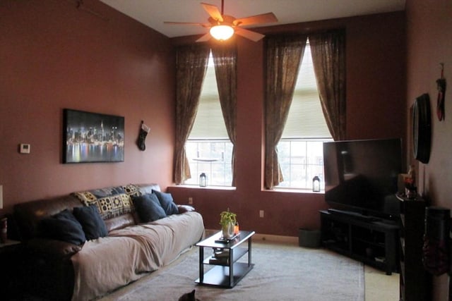 carpeted living room with ceiling fan