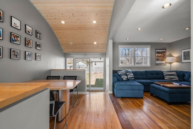 living area with wood ceiling, recessed lighting, baseboards, and light wood finished floors