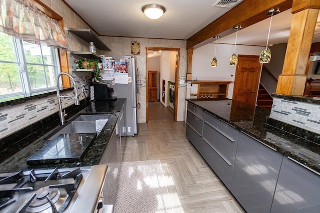 kitchen with modern cabinets, washer / clothes dryer, stainless steel appliances, gray cabinetry, and backsplash