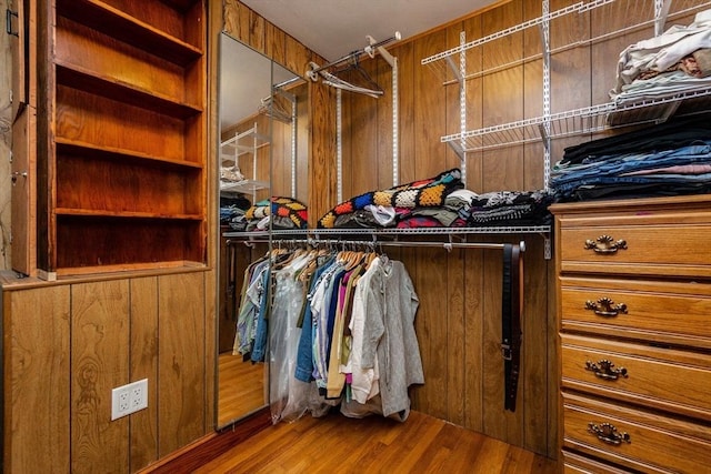walk in closet featuring wood finished floors