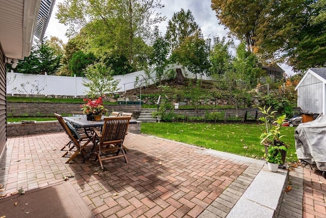 view of patio with outdoor dining area and a fenced backyard
