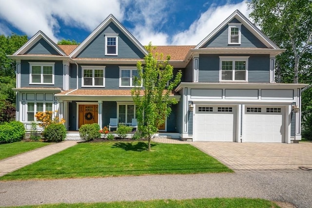 10 Damon Rd, Needham, MA 02494 - view of front facade featuring decorative driveway, a garage, a front lawn, and a porch
