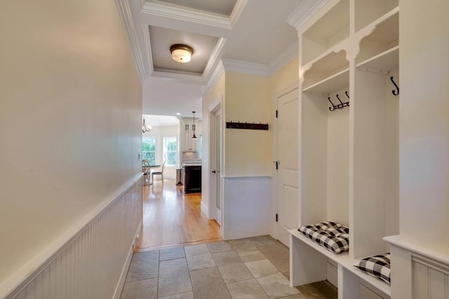 10 Damon Rd, Needham, MA 02494 - mudroom with crown molding, light stone finish flooring, and a chandelier