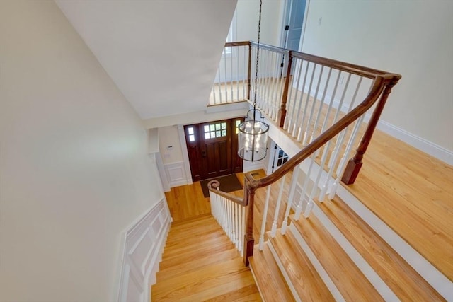 10 Damon Rd, Needham, MA 02494 - staircase featuring wood finished floors, high vaulted ceiling, and a chandelier