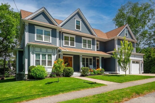 10 Damon Rd, Needham, MA 02494 - view of front facade with covered porch, a front lawn, concrete driveway, and an attached garage