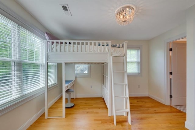 10 Damon Rd, Needham, MA 02494 - unfurnished bedroom with multiple windows, light wood finished floors, a chandelier, and baseboards