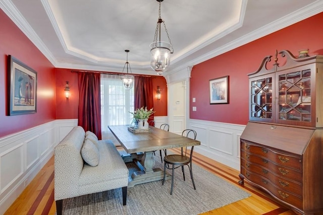 10 Damon Rd, Needham, MA 02494 - dining room featuring wood finished floors, a tray ceiling, a decorative wall, a wainscoted wall, and crown molding
