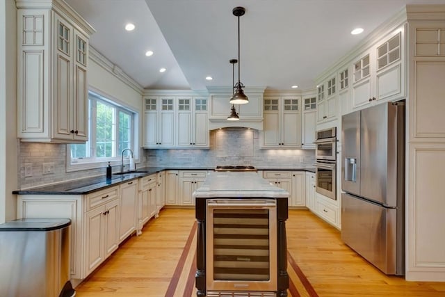 10 Damon Rd, Needham, MA 02494 - kitchen with stainless steel appliances, wine cooler, a sink, light wood-type flooring, and tasteful backsplash