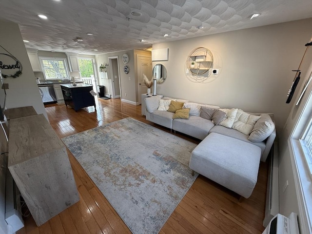 146 Main St Unit 2D, Clinton, MA 01510 - living area with recessed lighting, wood finished floors, and baseboards