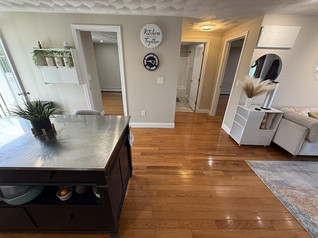 146 Main St Unit 2D, Clinton, MA 01510 - corridor featuring baseboard heating, hardwood / wood-style floors, and baseboards