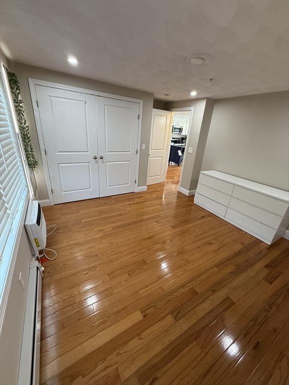 146 Main St Unit 2D, Clinton, MA 01510 - unfurnished bedroom with hardwood / wood-style floors, baseboards, recessed lighting, and a closet