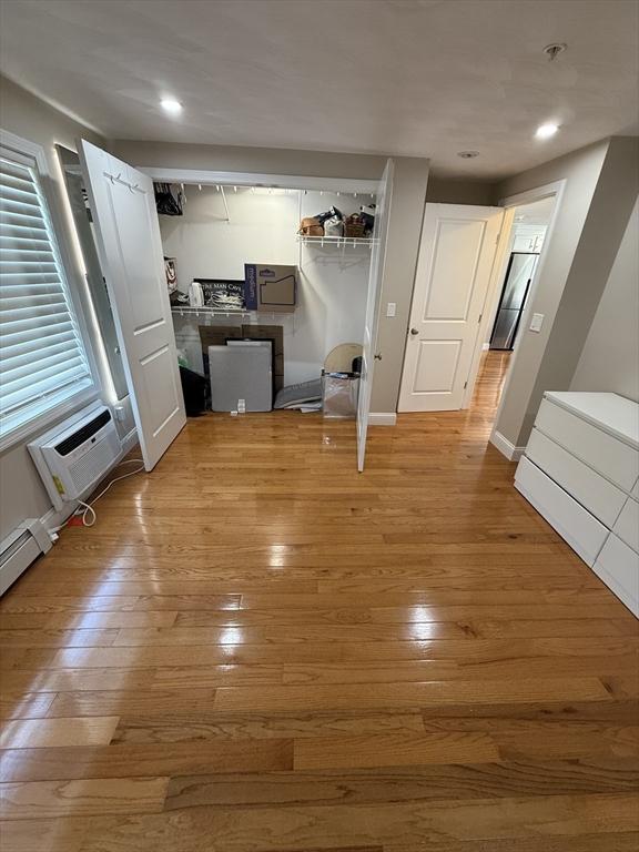 146 Main St Unit 2D, Clinton, MA 01510 - unfurnished living room featuring light wood-style floors, a wall mounted AC, and recessed lighting