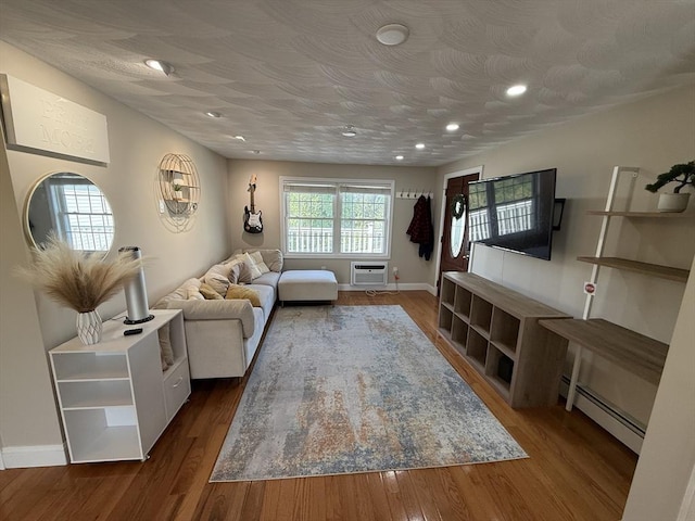 146 Main St Unit 2D, Clinton, MA 01510 - living room featuring a wall mounted air conditioner, a baseboard radiator, baseboards, wood finished floors, and recessed lighting
