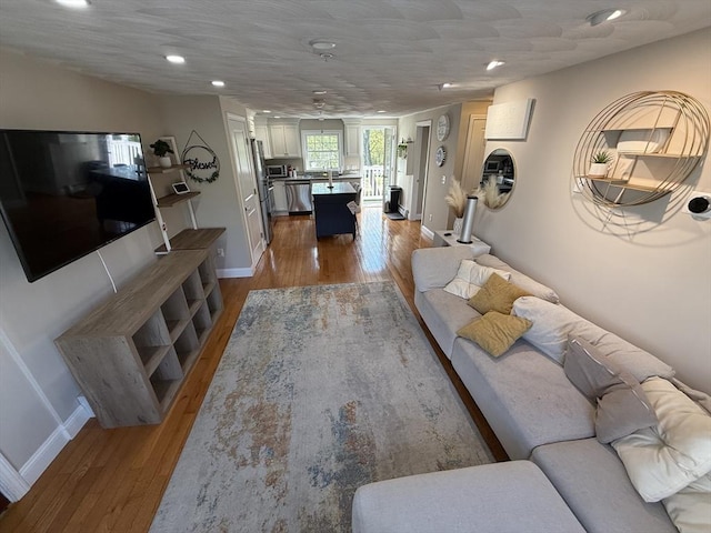 146 Main St Unit 2D, Clinton, MA 01510 - living room featuring wood finished floors, baseboards, and recessed lighting