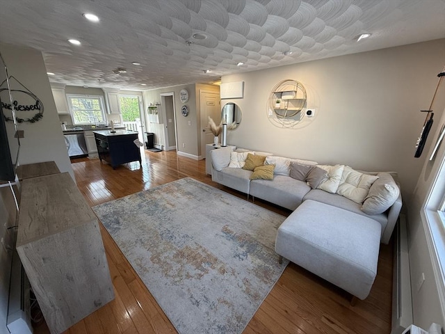 146 Main St Unit 2D, Clinton, MA 01510 - living room with recessed lighting, wood finished floors, and baseboards