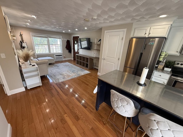 146 Main St Unit 2D, Clinton, MA 01510 - kitchen featuring stainless steel appliances, white cabinets, baseboards, and recessed lighting
