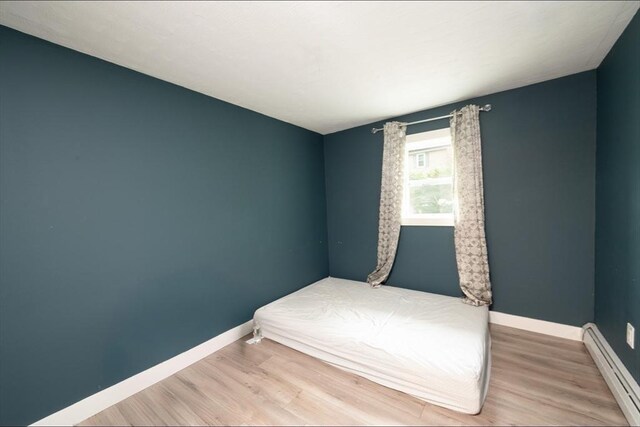 67 Raymond Rd, Plymouth, MA 02360 - bedroom featuring a baseboard radiator and wood finished floors