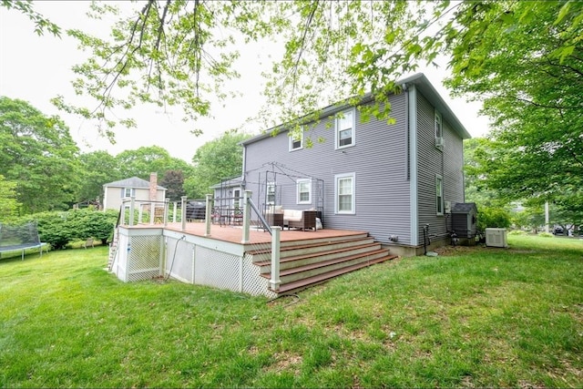 67 Raymond Rd, Plymouth, MA 02360 - back of property with a trampoline, a deck, and a lawn