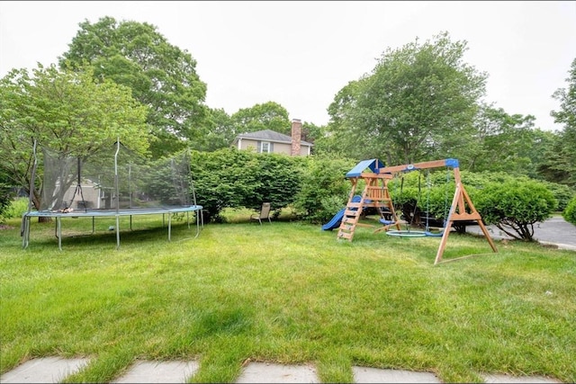 67 Raymond Rd, Plymouth, MA 02360 - view of grassy yard with a trampoline, a playground, and view of wooded area