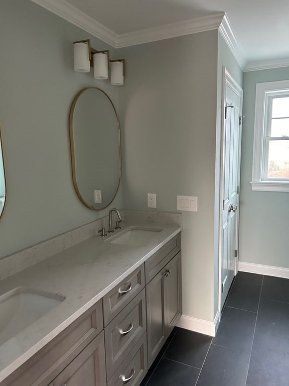 bathroom featuring tile patterned flooring, ornamental molding, and vanity