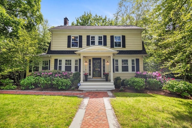 19 Whittier Rd, Wellesley, MA 02481 - view of front of house featuring a front yard, a chimney, and roof with shingles