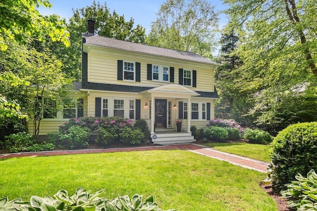 19 Whittier Rd, Wellesley, MA 02481 - view of front facade featuring a chimney, a front yard, and roof with shingles