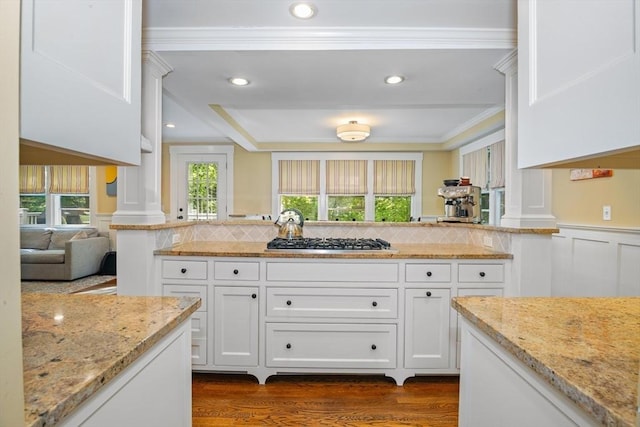 19 Whittier Rd, Wellesley, MA 02481 - kitchen with stainless steel gas cooktop, crown molding, dark wood-style floors, white cabinets, and light stone countertops