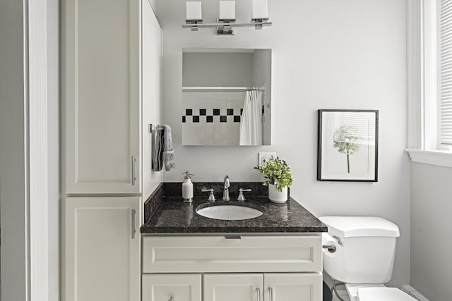 full bathroom with toilet, curtained shower, and vanity