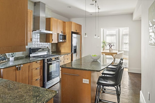 kitchen with a breakfast bar, backsplash, a kitchen island, wall chimney exhaust hood, and stainless steel appliances